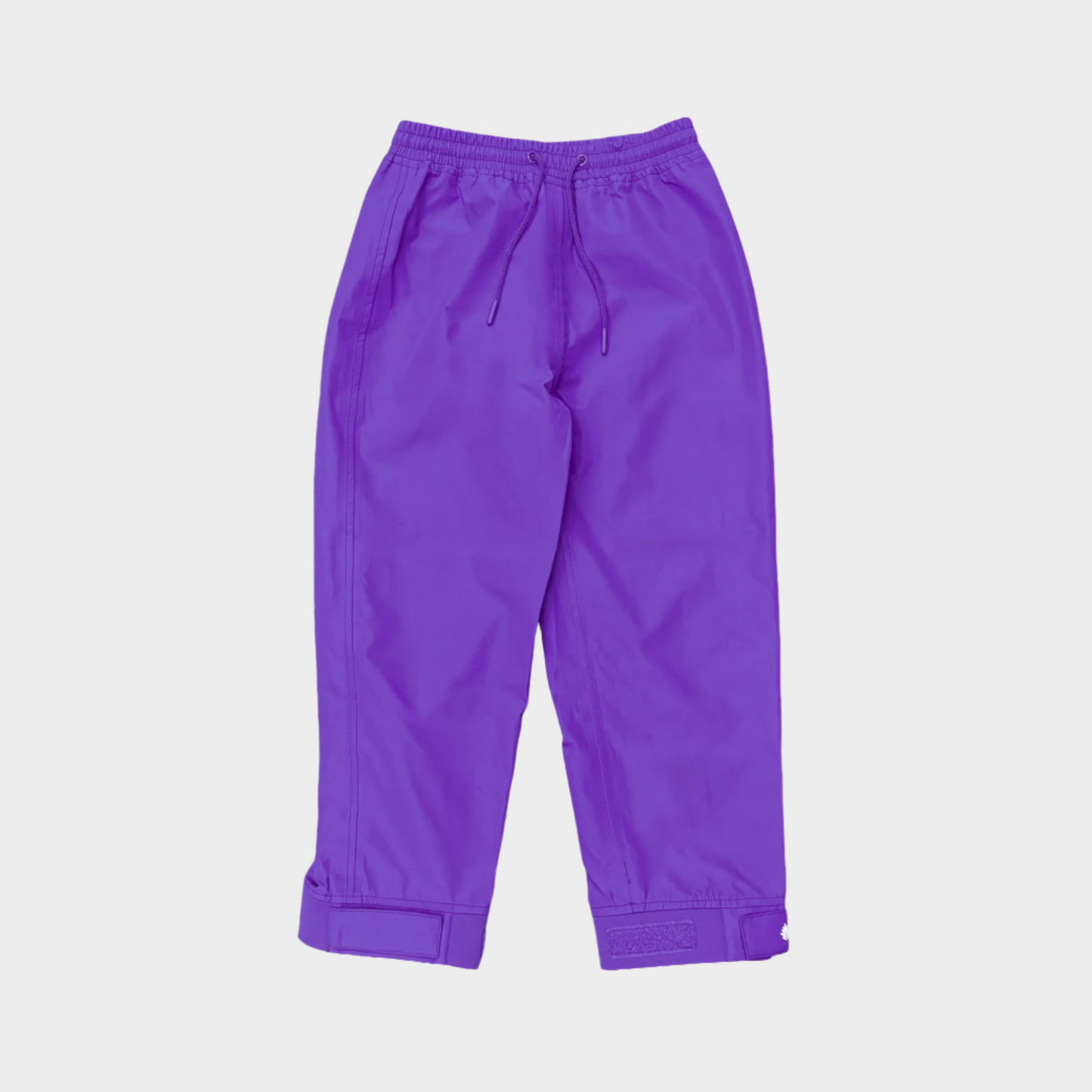 A pair of kids rain pants with an elastic waistband and drawstring. Ankles have a neoprene covered velcro adjustment. Shown in solid purple