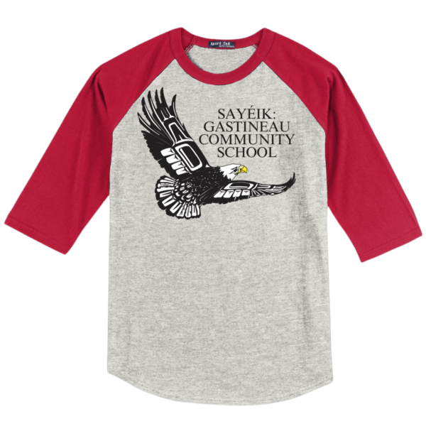 A gray baseball tee with a full front print of a bald eagle and text that says 'SAYEIK GASTINEAU COMMUNITY SCHOOL'. It has red sleeves with a rib knit neck and 3/4 raglan sleeves.