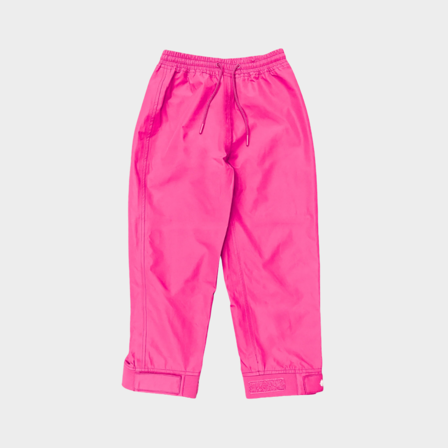 A pair of kids rain pants with an elastic waistband and drawstring. Ankles have a neoprene covered velcro adjustment. Shown in bright pink