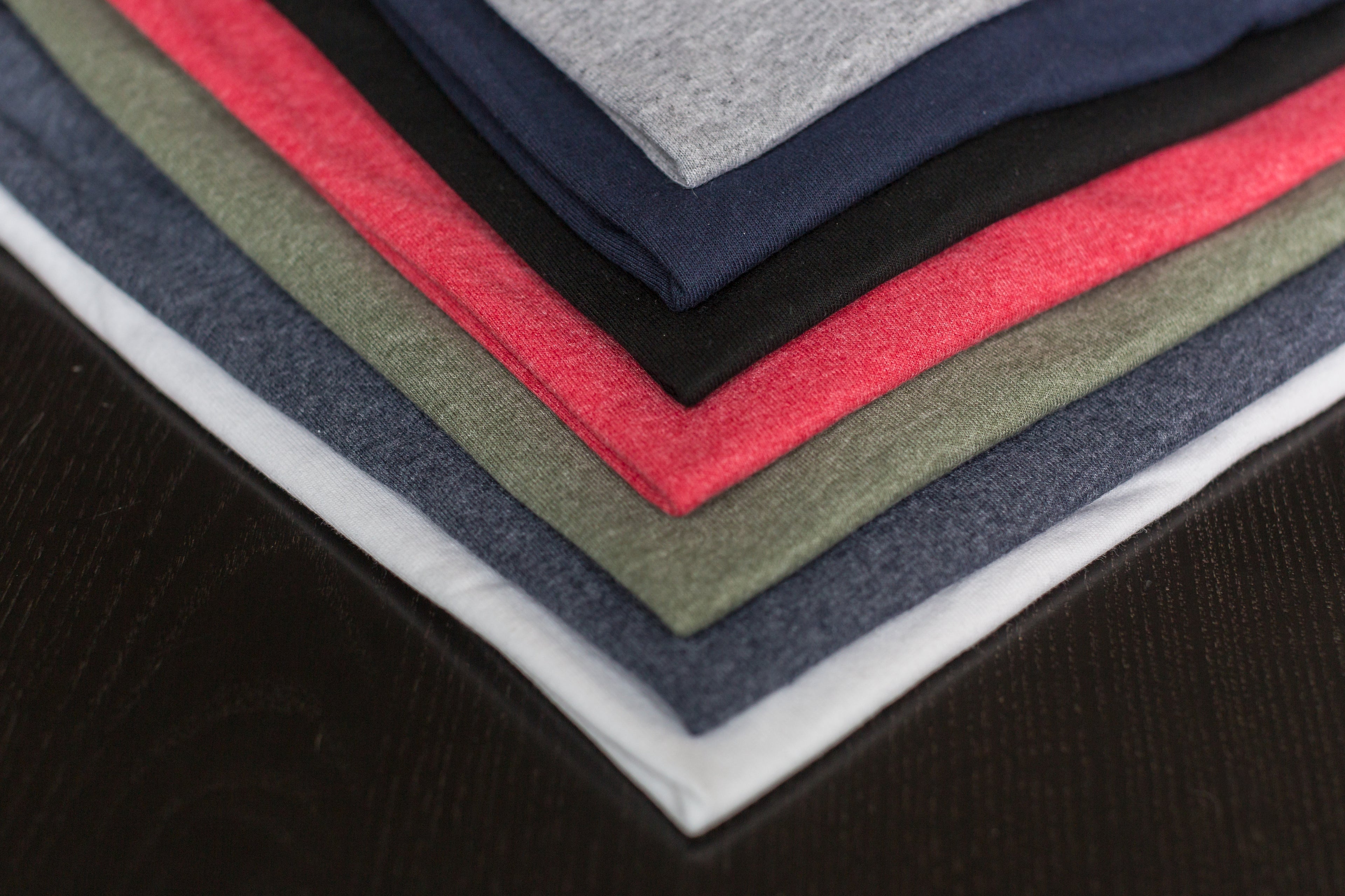 Stock image close up of the corner of variously colored shirts