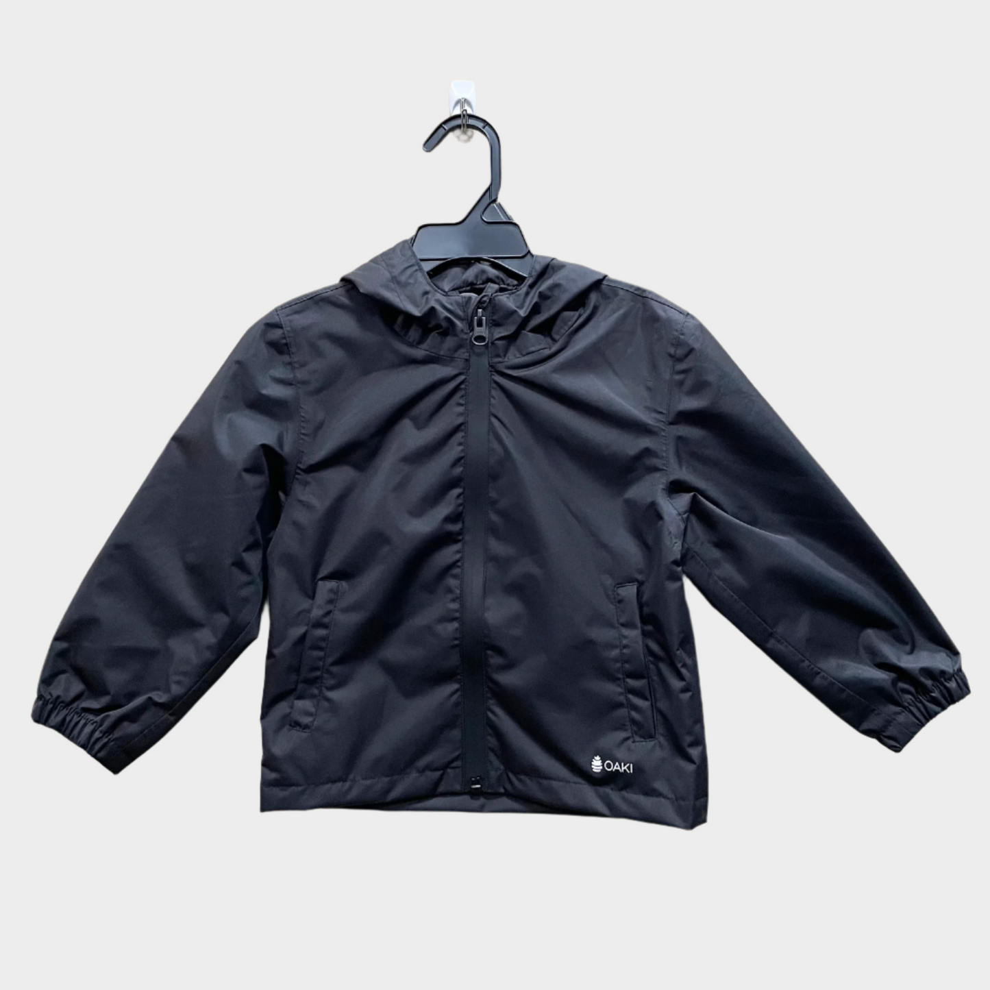 Kids rain shell with hood and a front pocket each side. Shown in orange