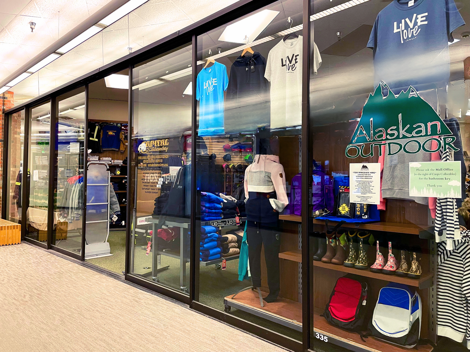 Store interior with clothing and outdoor gear displayed in a retail setting