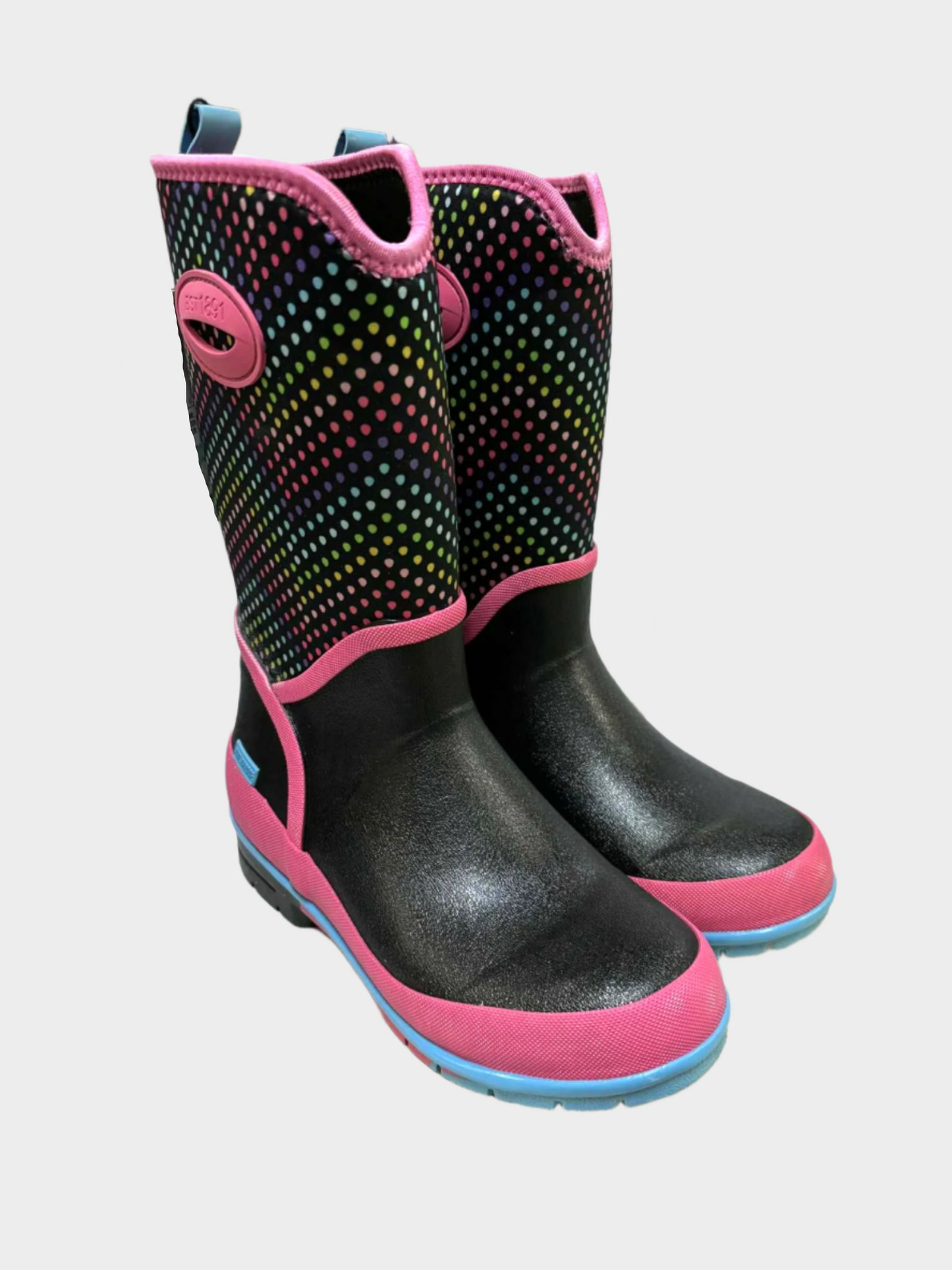 Black and pink rain boots with colorful dots on the upper on a white surface