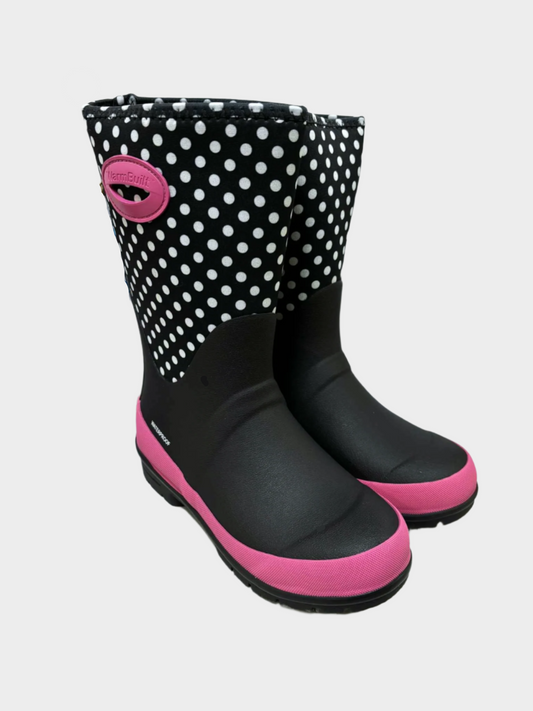 Black and pink polka dot rain boots on a white surface.