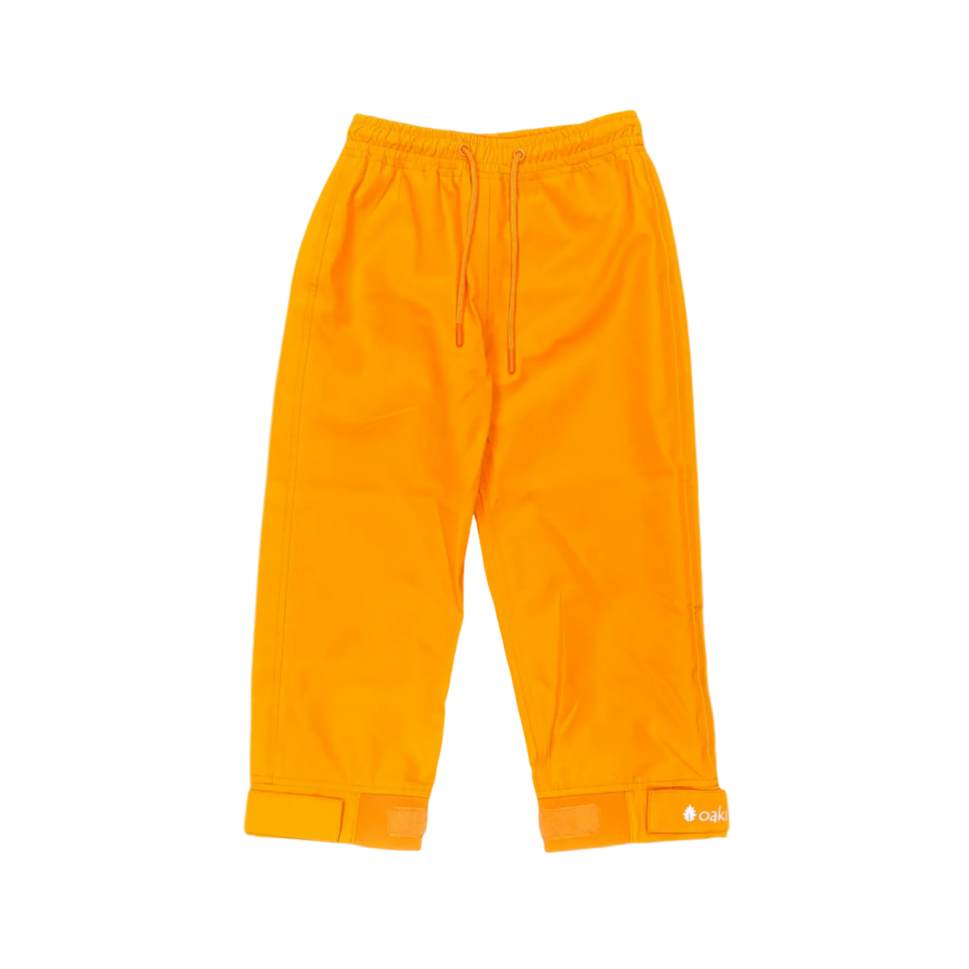 A pair of kids rain pants with an elastic waistband and drawstring. Ankles have a neoprene covered velcro adjustment. Shown in lava orange