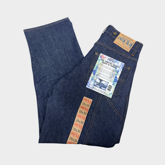 A pair of folded blue work jeans. Includes suspender buttons.
